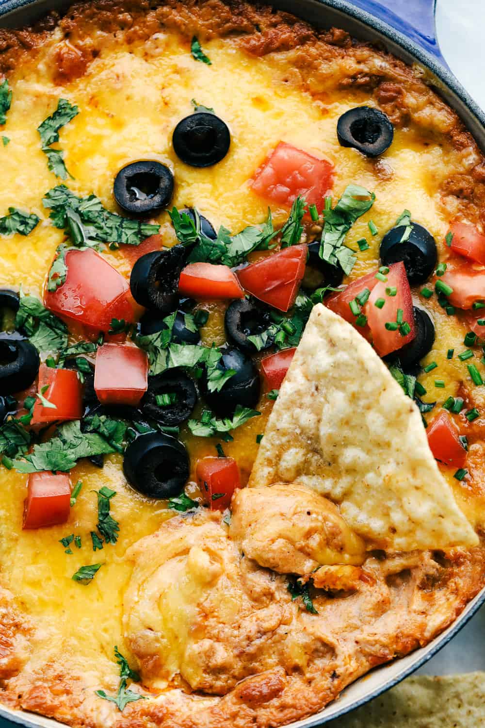 Bean dip cooked with a chip in the middle of it.