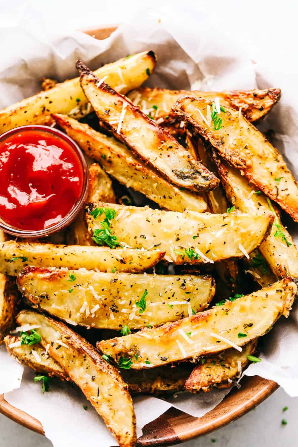 Baked Parmesan Garlic Potato Wedges served with ketchup.