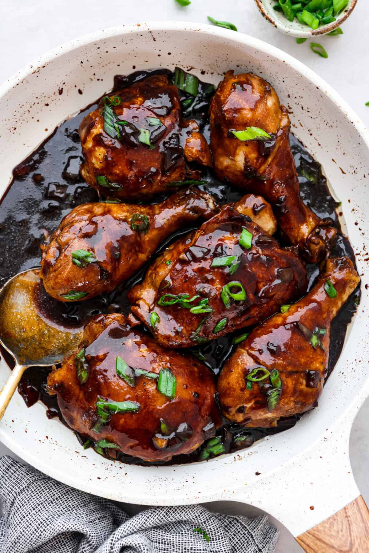 Overhead shot of chicken adobo in skillet. 