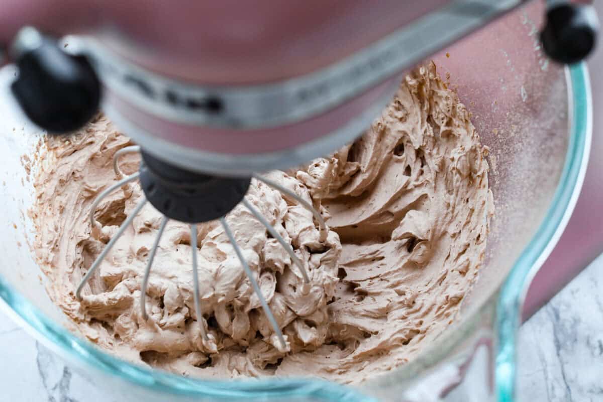 Overhead shot of chocolate whipped cream in stand mixer. 