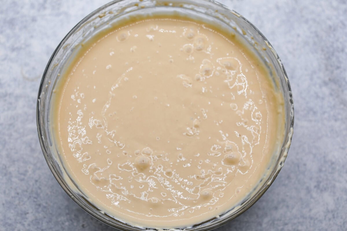 Overhead shot of mixed cream cheese filling in glass bowl. 