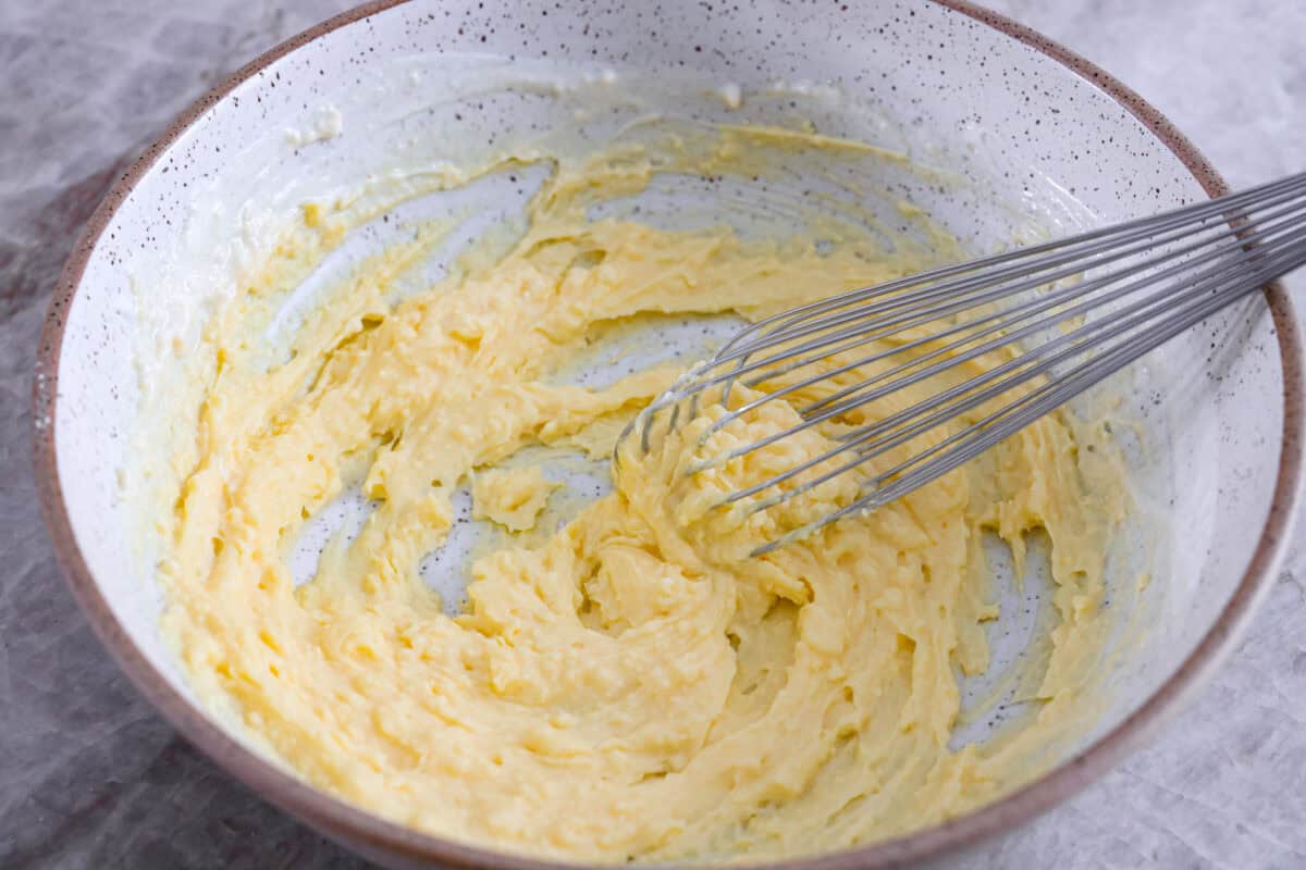 First process photo of the buttermilk and pudding mixed in a bowl.