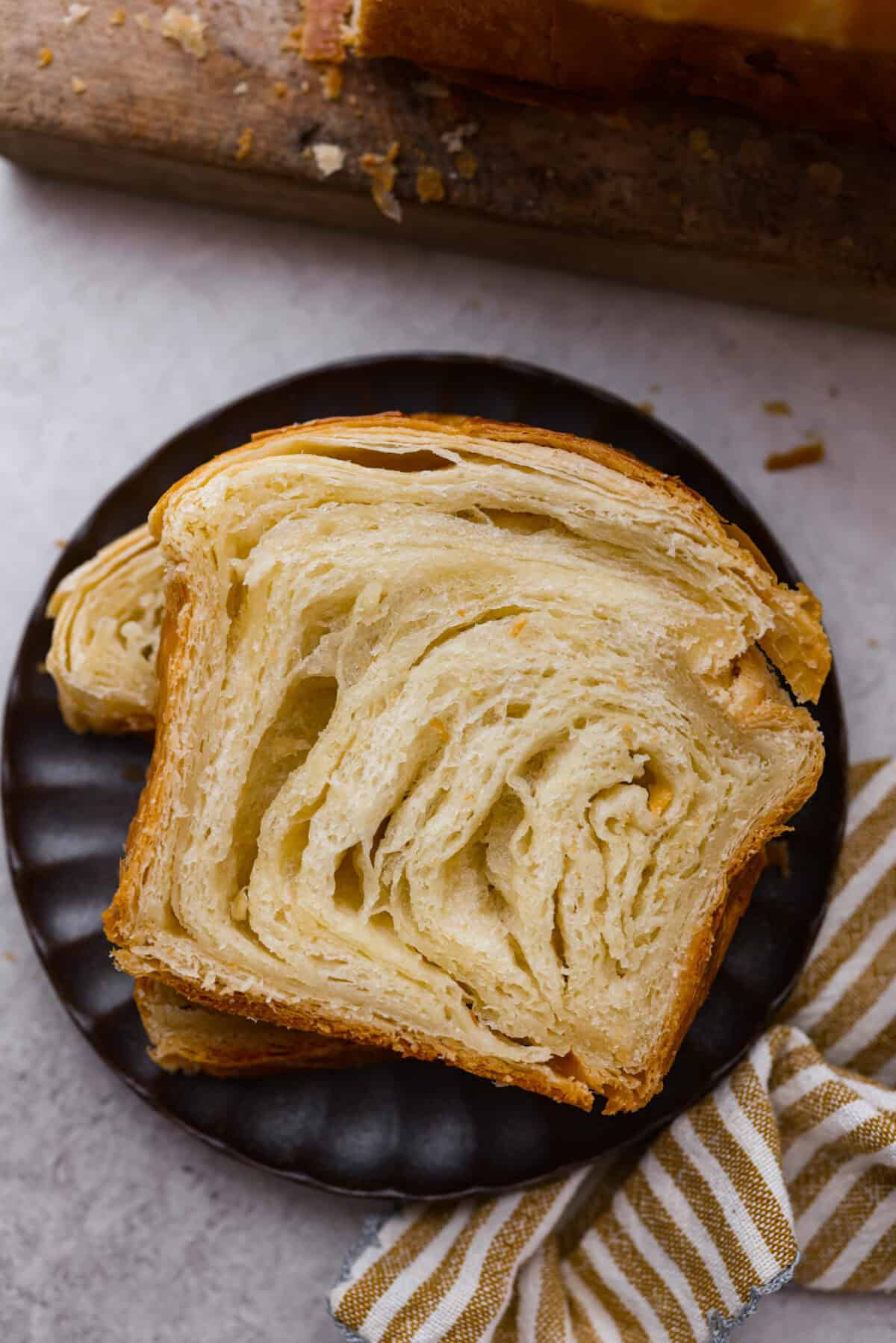 Overhead shot of plated slices of croissant bread. 