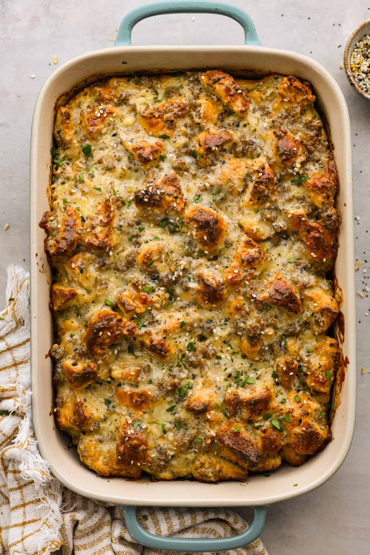 Overhead view of everything bagel casserole in a baking dish.