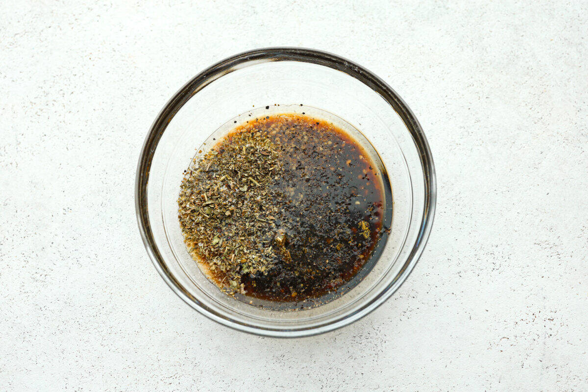 Overhead shot of marinade ingredients in a glass bowl. 