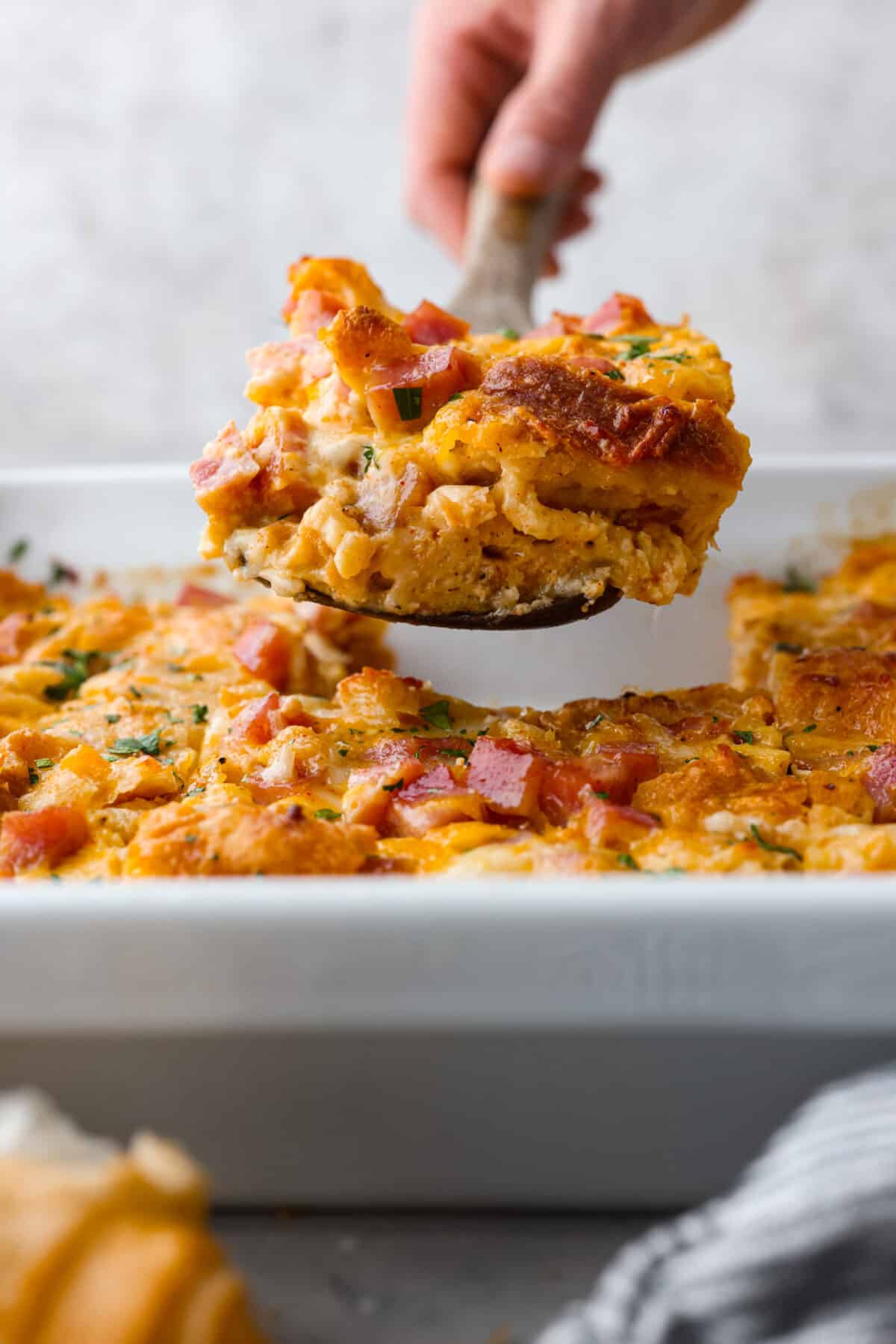 The side view of a slice of casserole being served. 