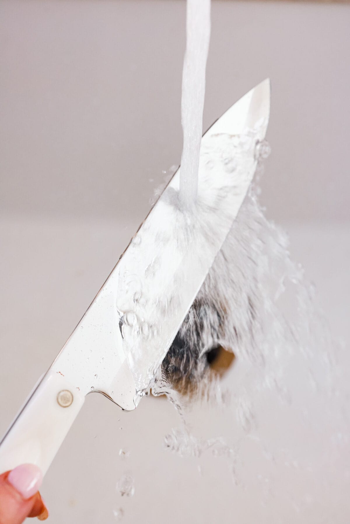 First photo of hot water running on a knife.