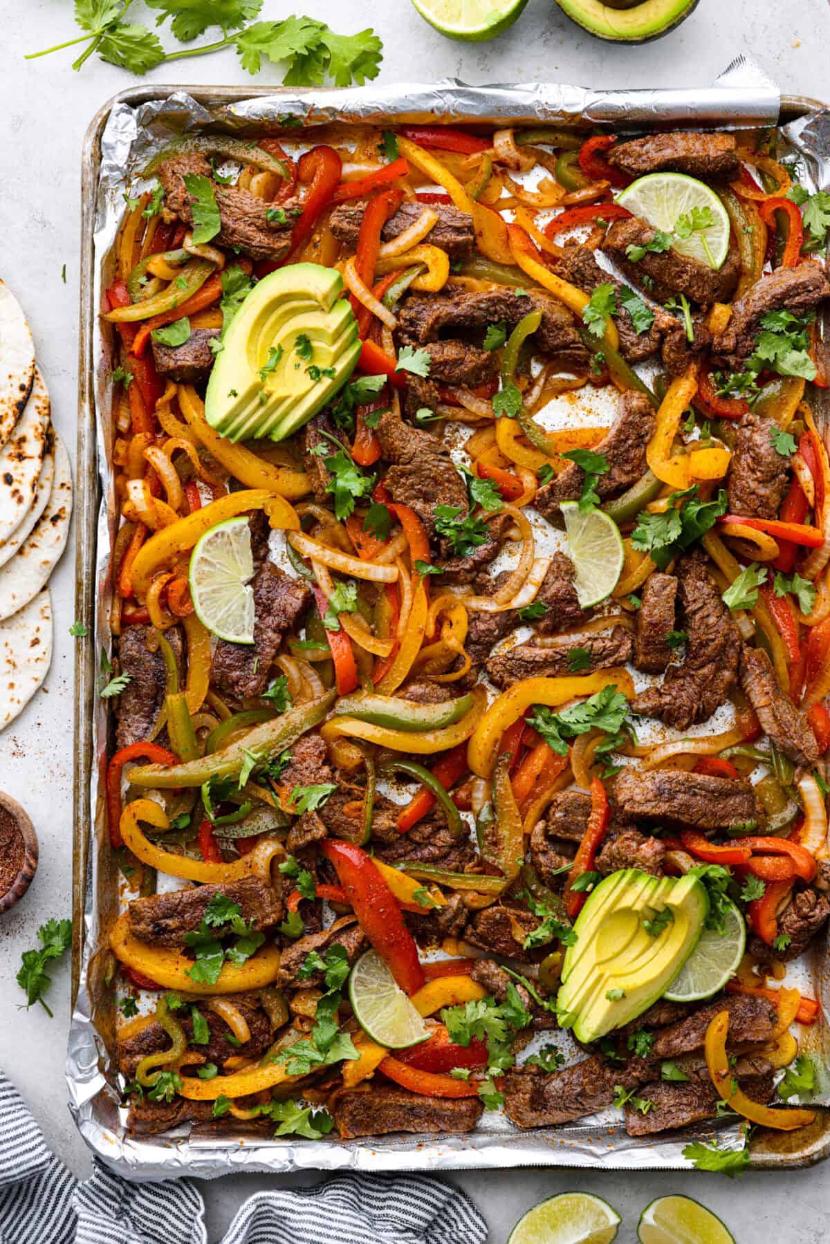 Overhead shot of cooked sheet pan steak fajitas. 