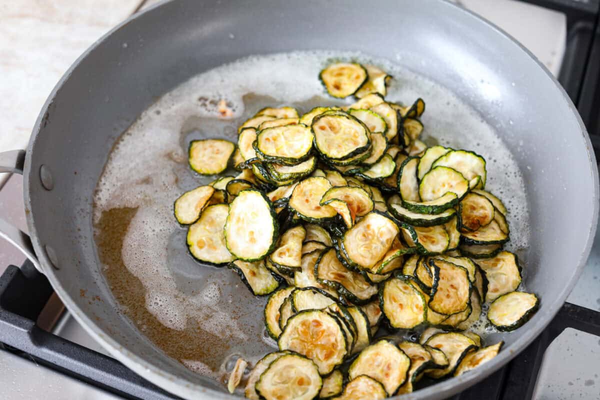 Fourth photo of the chilled fried zucchini added to the skillet.