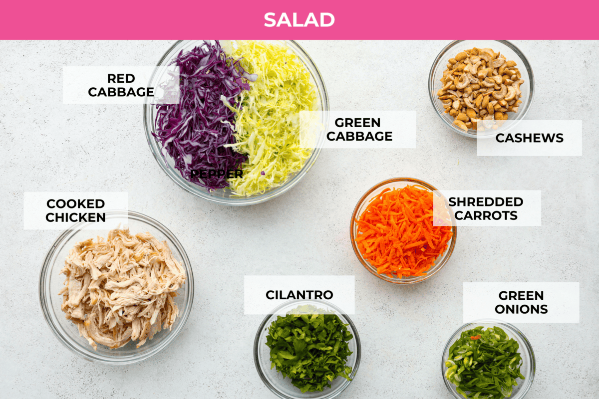 The top view of ingredients on a counter, all in glass bowls and labeled. 