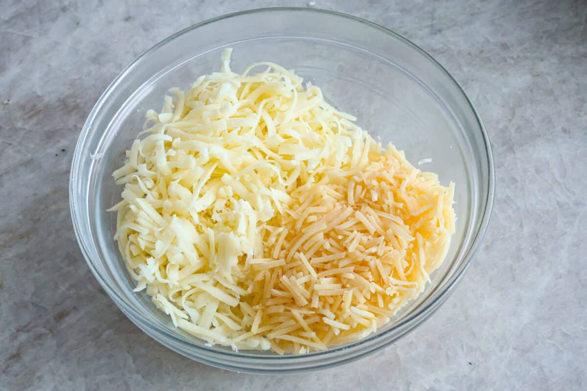 Angle shot of cheeses in a glass bowl. 