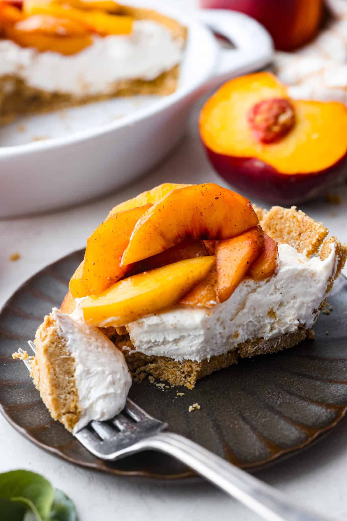 Angle shot of a plated slice of the no-bake fresh peach pie. 