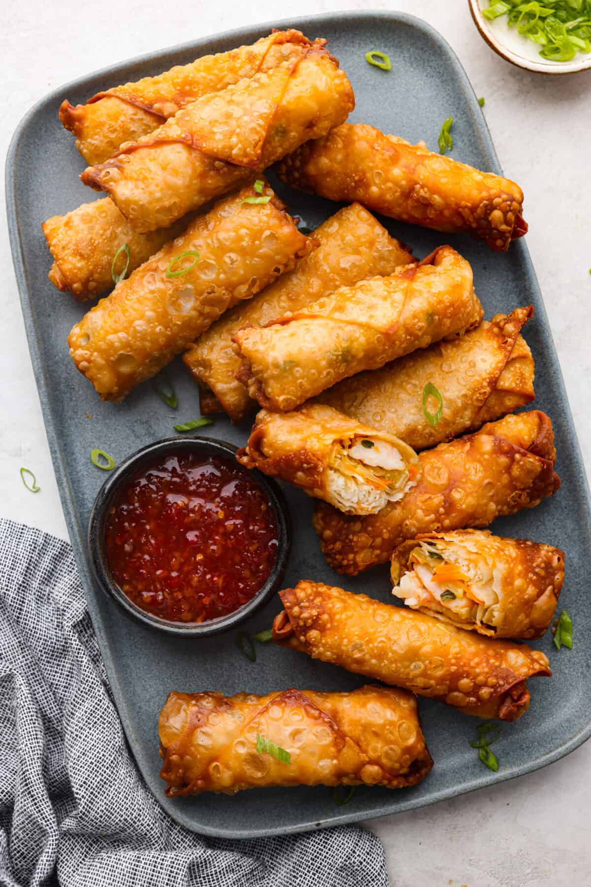 Overhead shot of a plate full of fried shrimp egg rolls. 