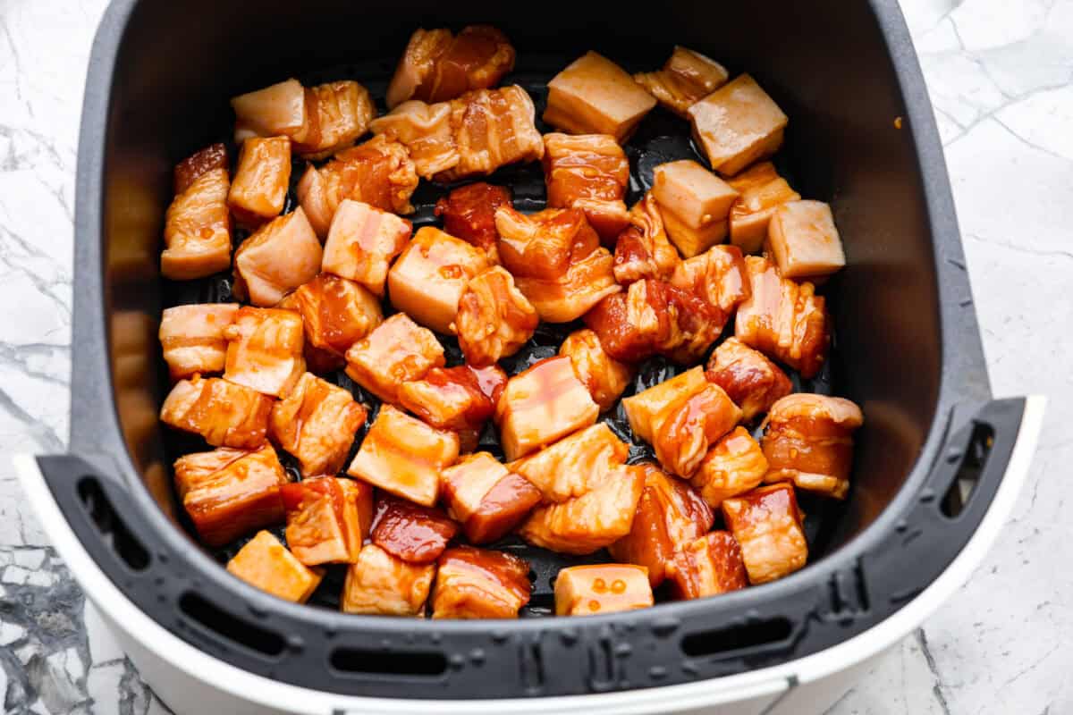 Overhead shot of marinated pole in the air fryer basket. 