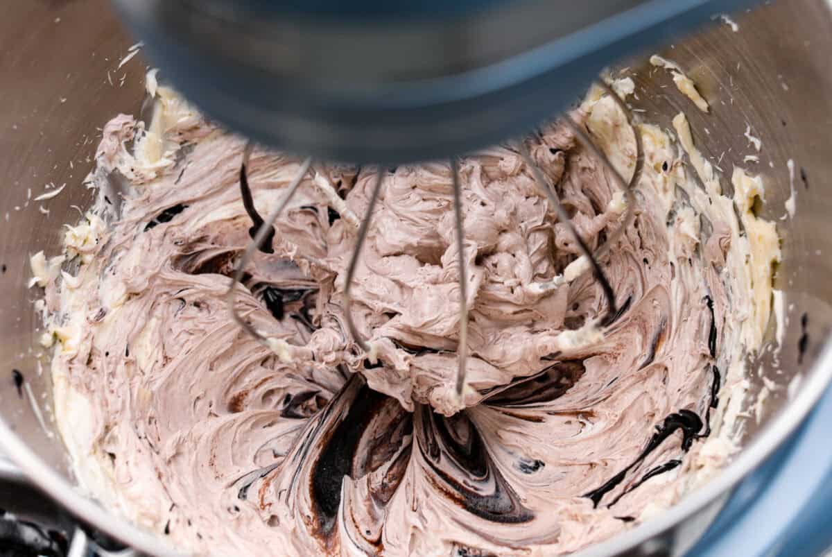 Overhead shot of the cooled sugar and milk mixture being incorporated into the whipped butter. 