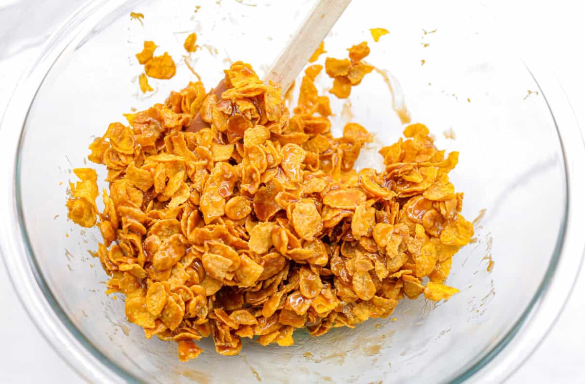 Overhead shot of cornflakes mixed with the butter and sugar mixture. 