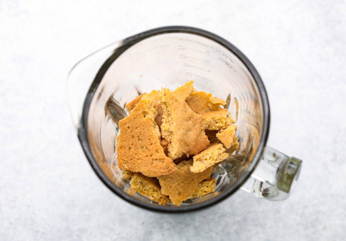 Overhead shot of oatmeal cookie chunks in a blender. 