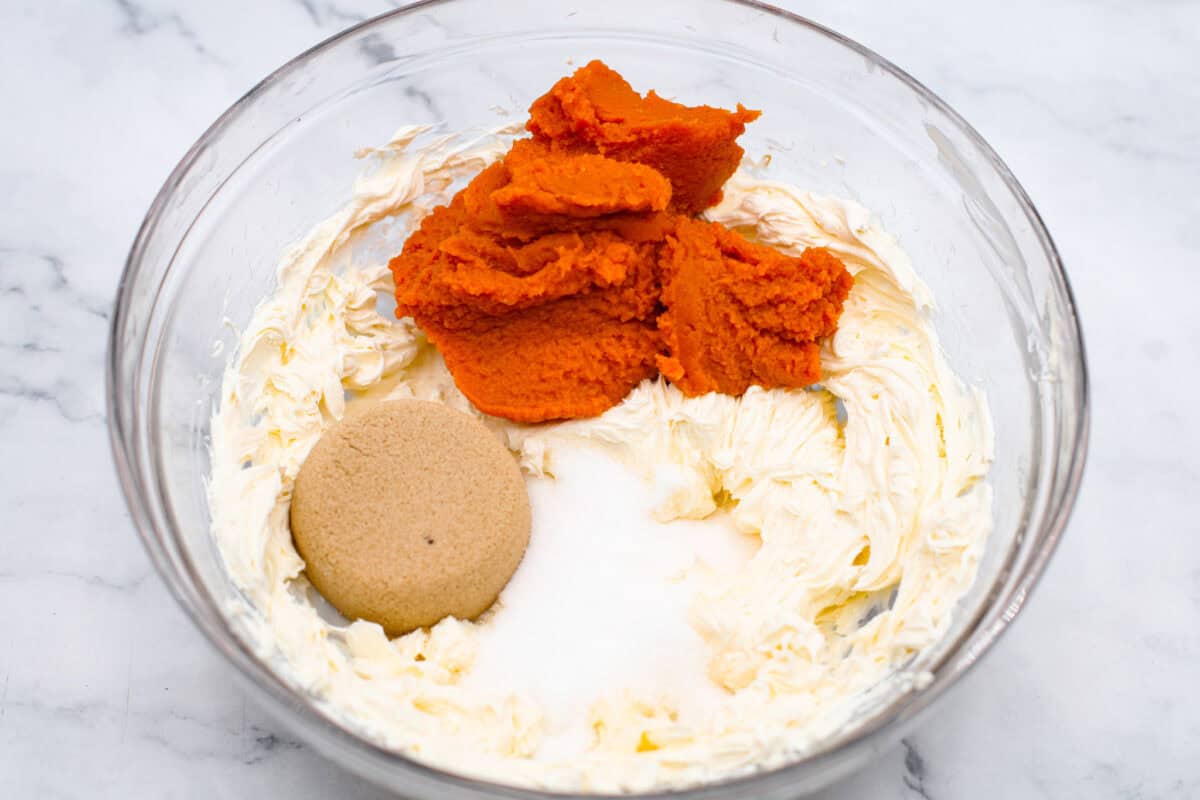 Overhead shot of whipped cream cheese with sugars, pumpkin and 