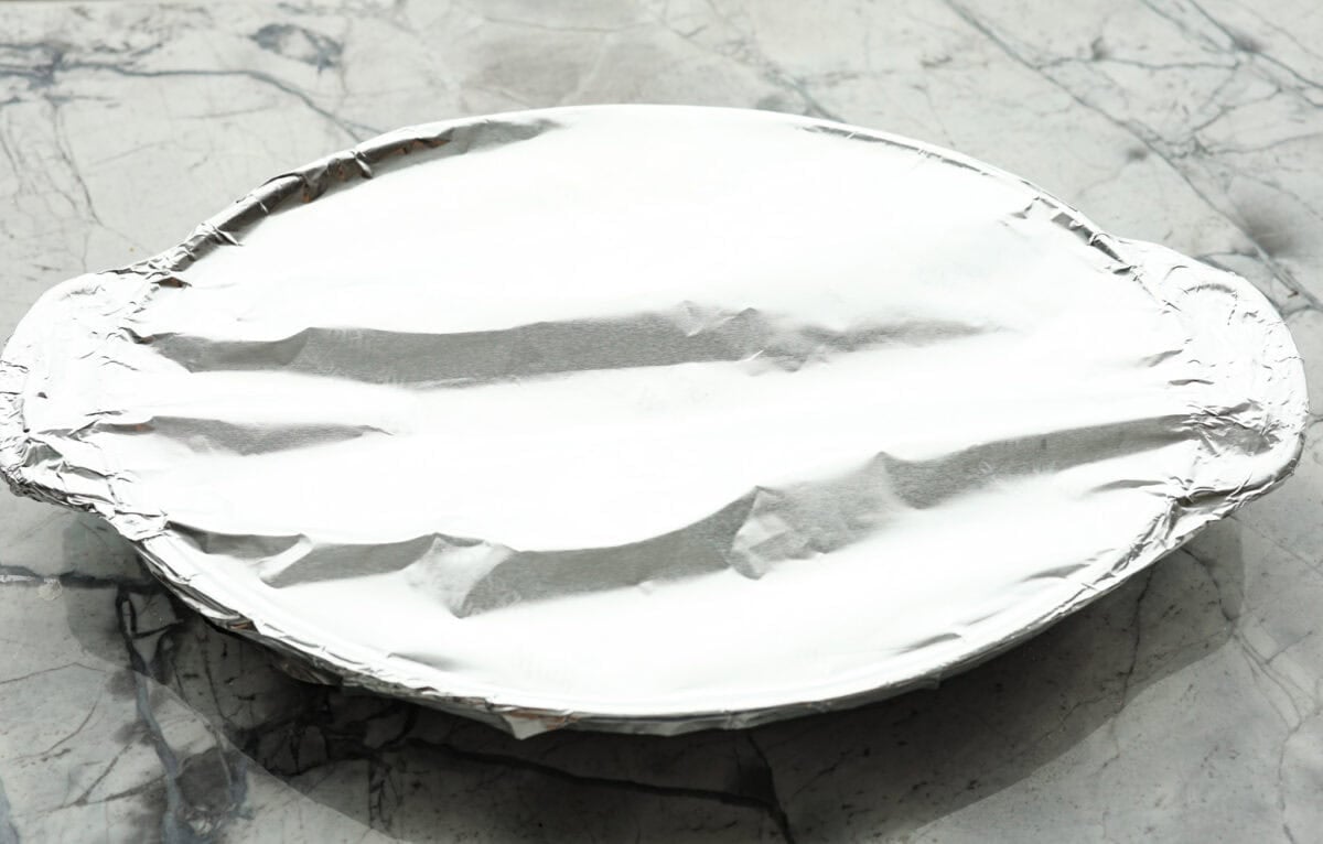 Overhead shot of baking dish with aluminum foil over the top. 