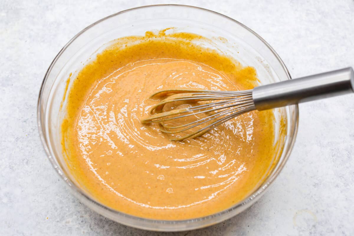 Fifth photo of the pumpkin layer mixed in a bowl.