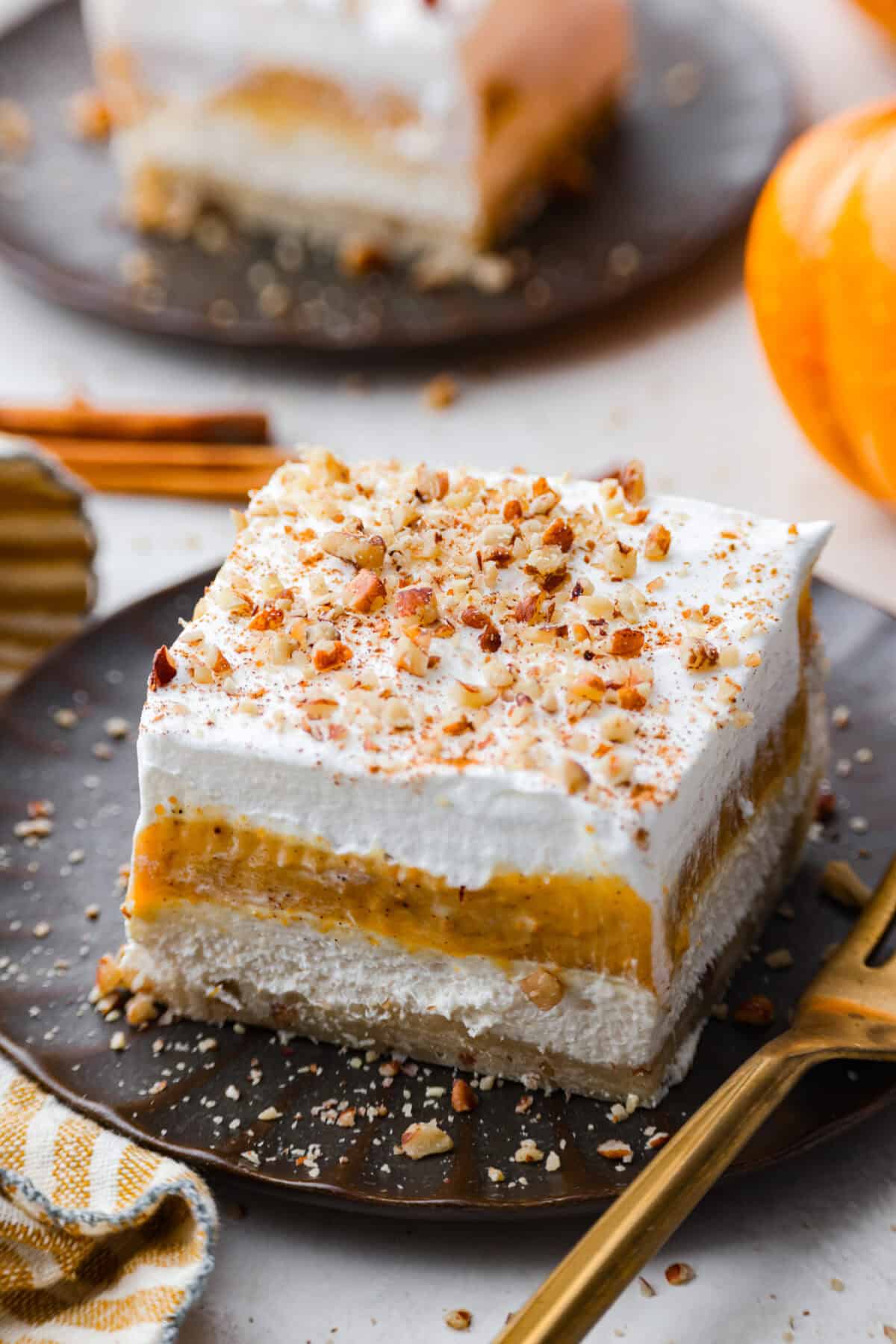 Close view of a slice of pumpkin delight on a plate with a fork.