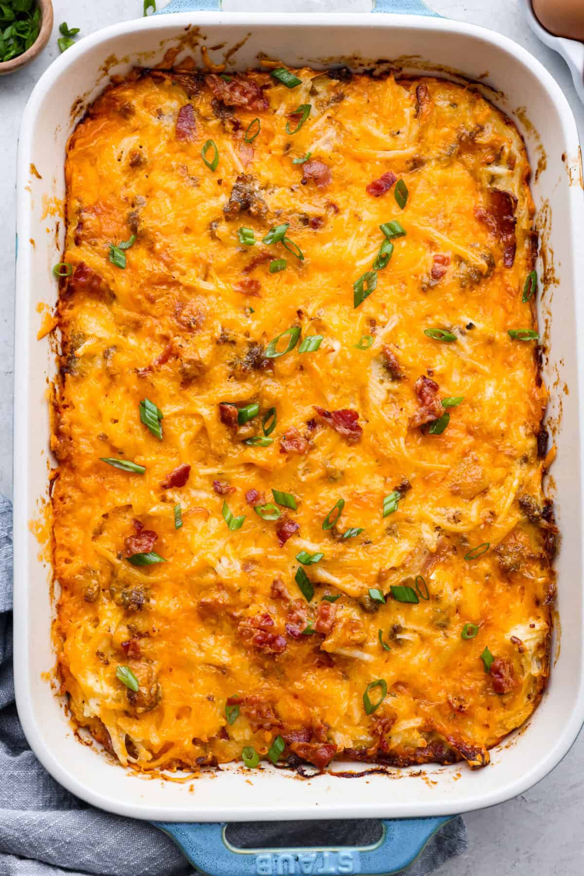 Overhead shot of crack breakfast casserole in a baking dish. 