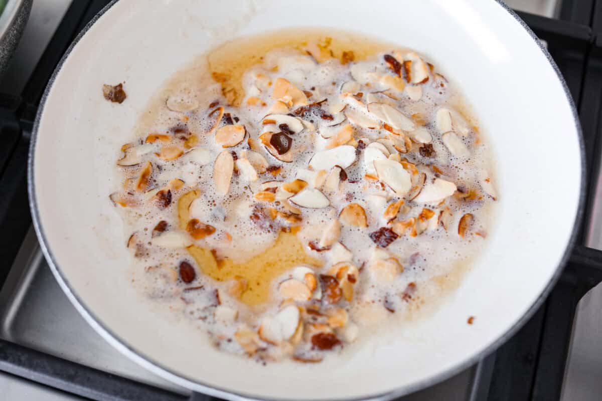 Overhead shot of butter browning with the toasted almonds. 