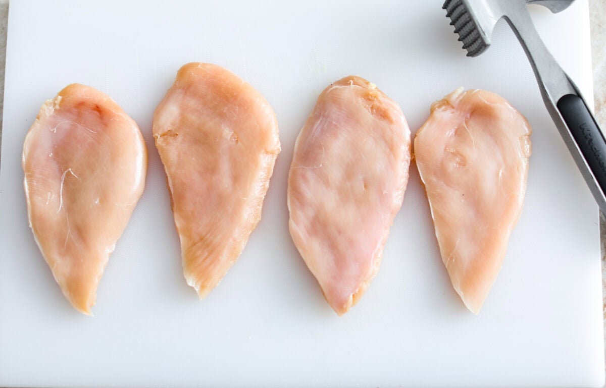 Overhead shot of tenderized chicken breasts. 