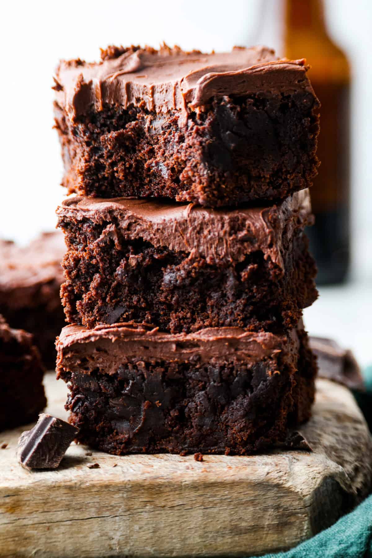 Rich, fudgy, and packed with deep chocolate flavor, Guinness Brownies are a must-try for any dessert lover! The stout beer enhances the cocoa, adding a subtle, malty depth of flavor that makes these brownies rich and irresistibly delicious. Close up shot of a stack of Guinness brownies.