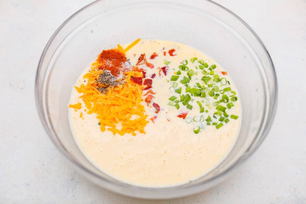 My Hash Brown Crust Quiche is a gluten-free twist on a classic! Crispy, golden potatoes wrap around a rich, savory, custardy filling. Brunch just got an upgrade! Filling ingredients together in a mixing bowl.