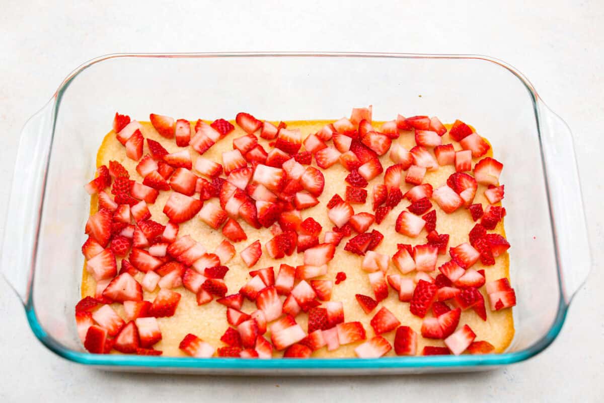 Fresh cut strawberries on top of the crust layer. 