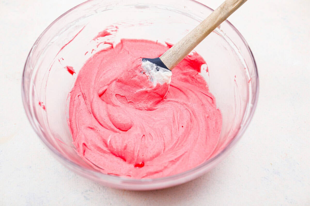 Strawberry jello layer ingredients mixed together in a bowl.