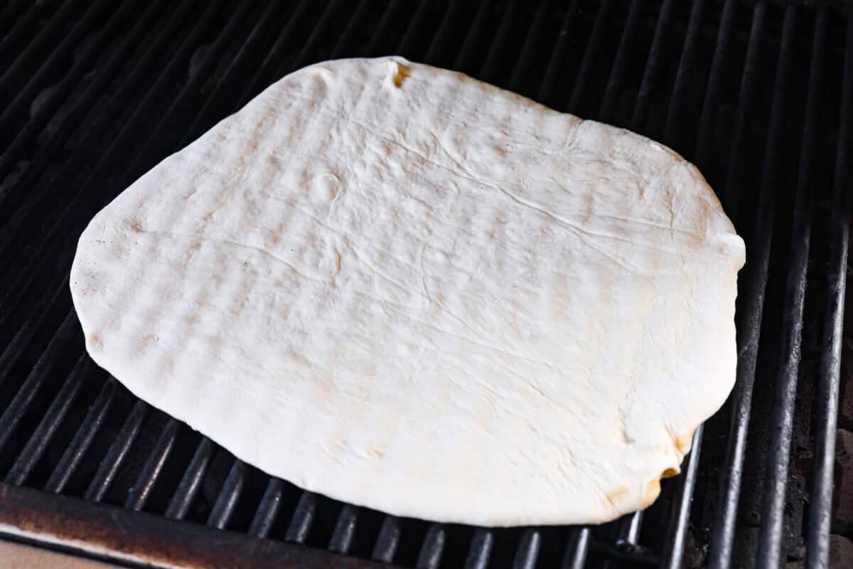 Pizza dough on the grill.