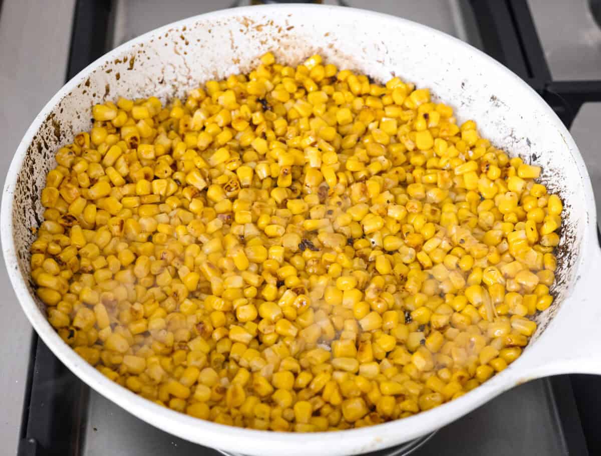 Corn sautéing in a skillet. 