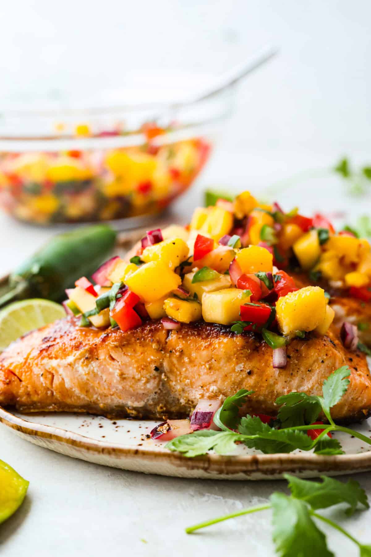 Side shot of plated mango salsa salmon. 