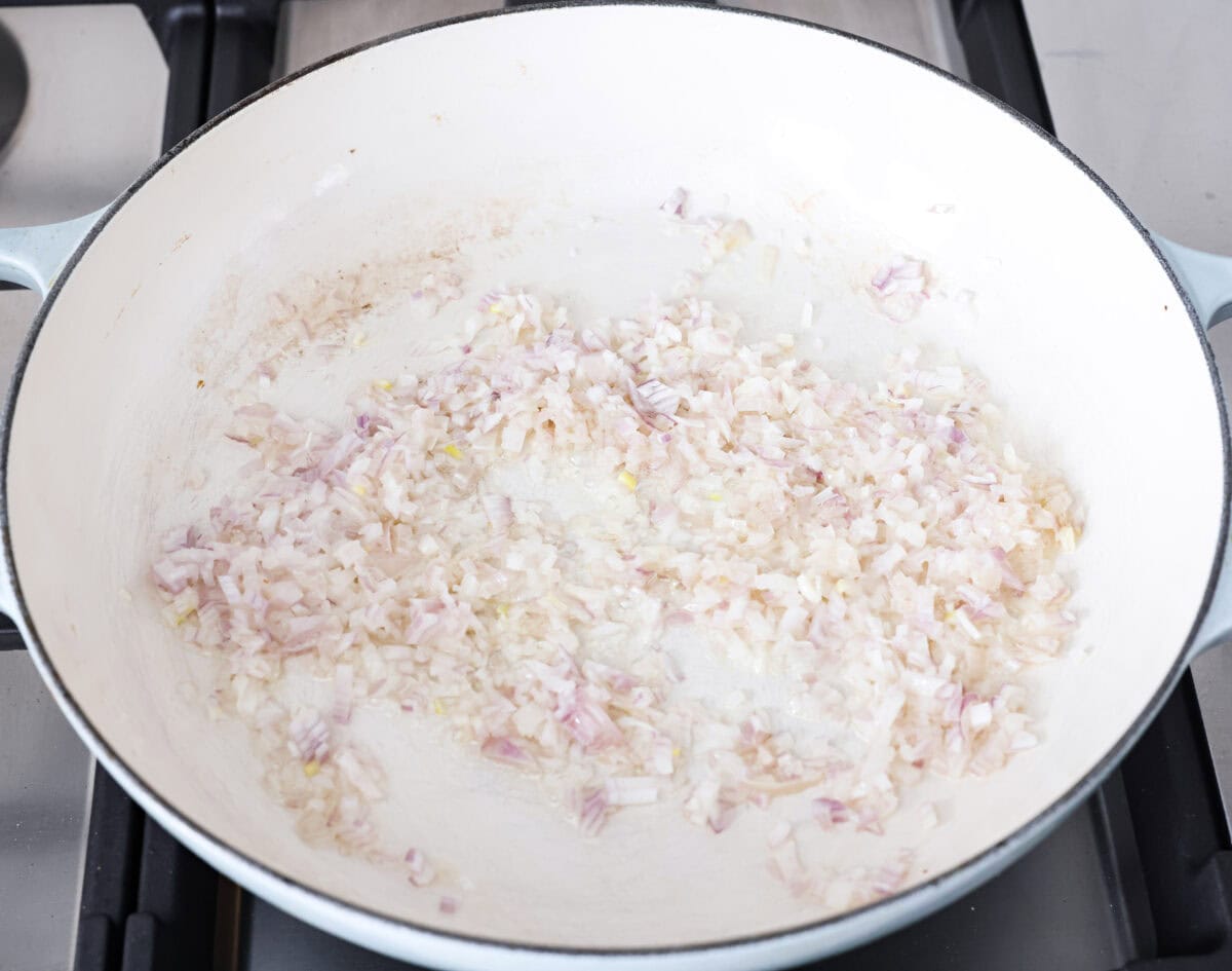 Shallots and butter cooking in a skillet.
