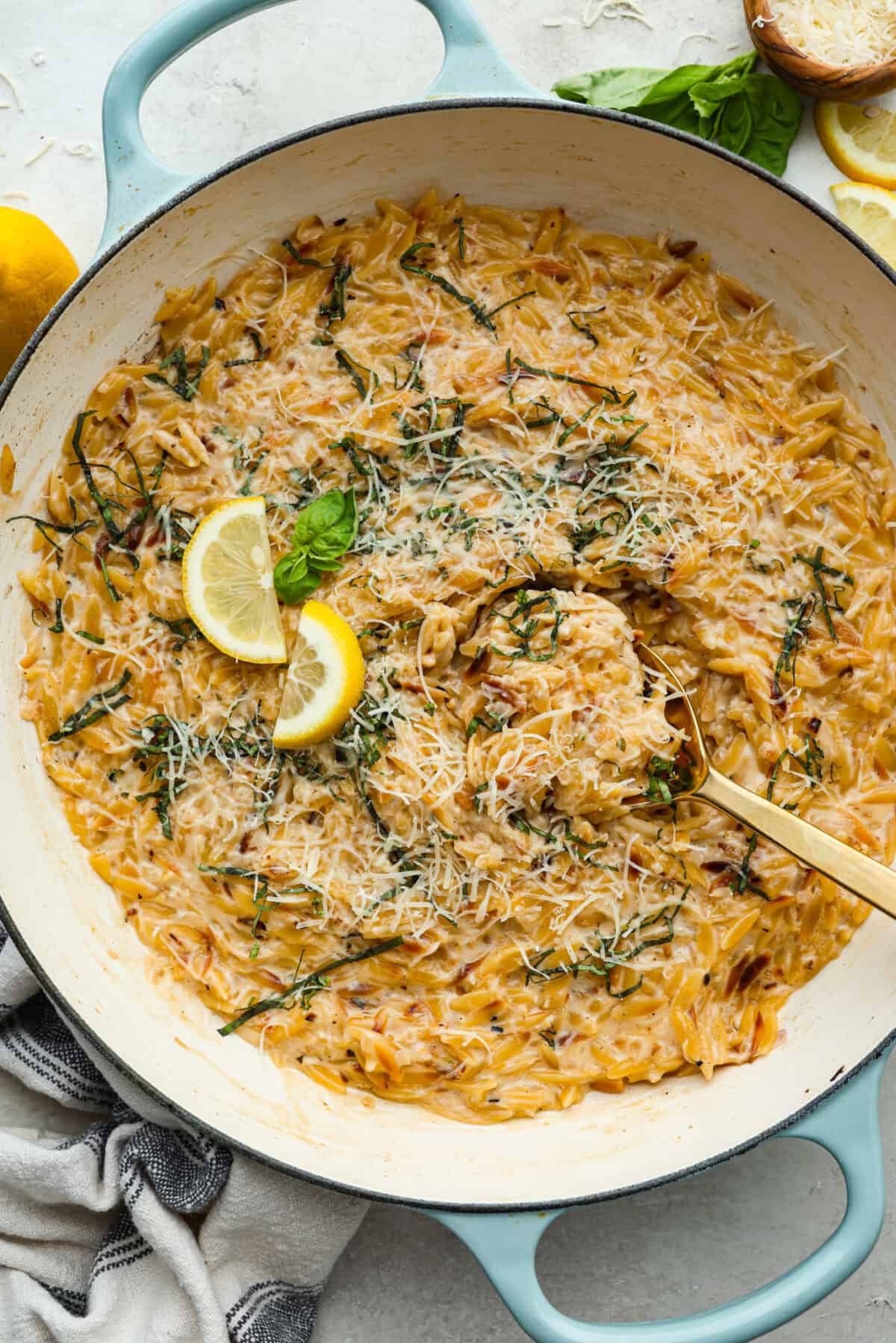 Cooked creamy lemon orzo in a skillet. 