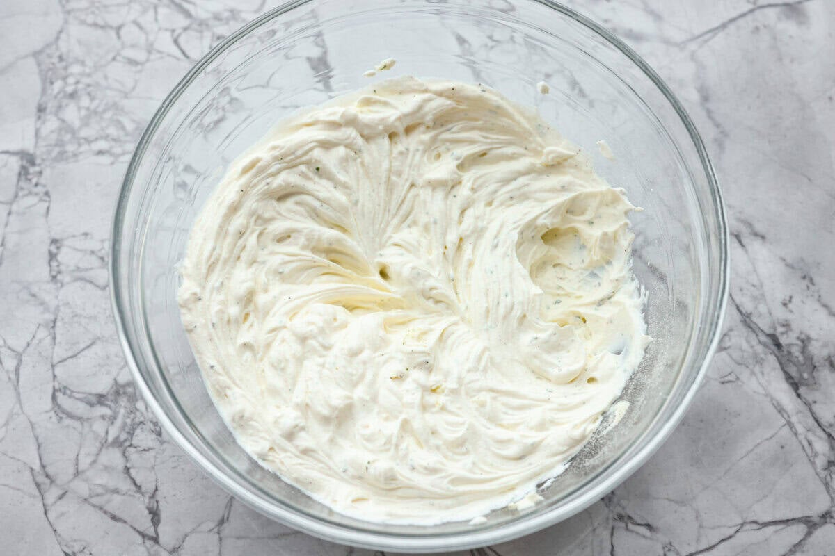 Cream cheese, sour cream, and ranch dressing mix all whipped together in a bowl. 