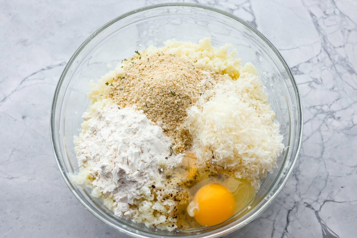 Seasonings, breadcrumbs and egg added to the mashed up cauliflower. 