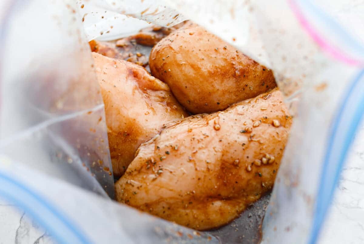 Marinade in a bag with raw chicken breasts added to it and coated in the marinade. 