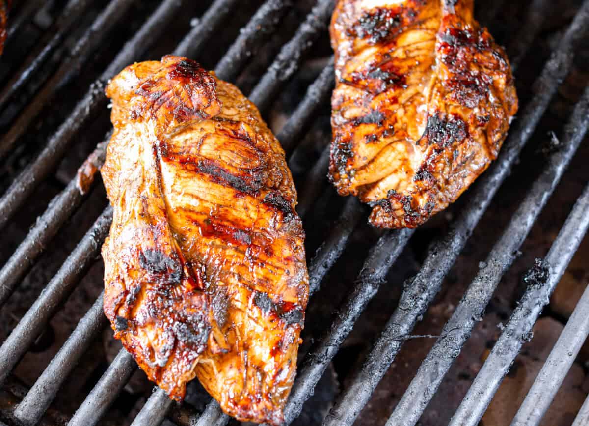 Marinated chicken cooking on the grill. 