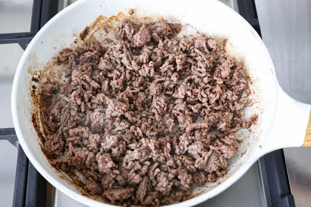 Ground beef cooking in a skillet. 