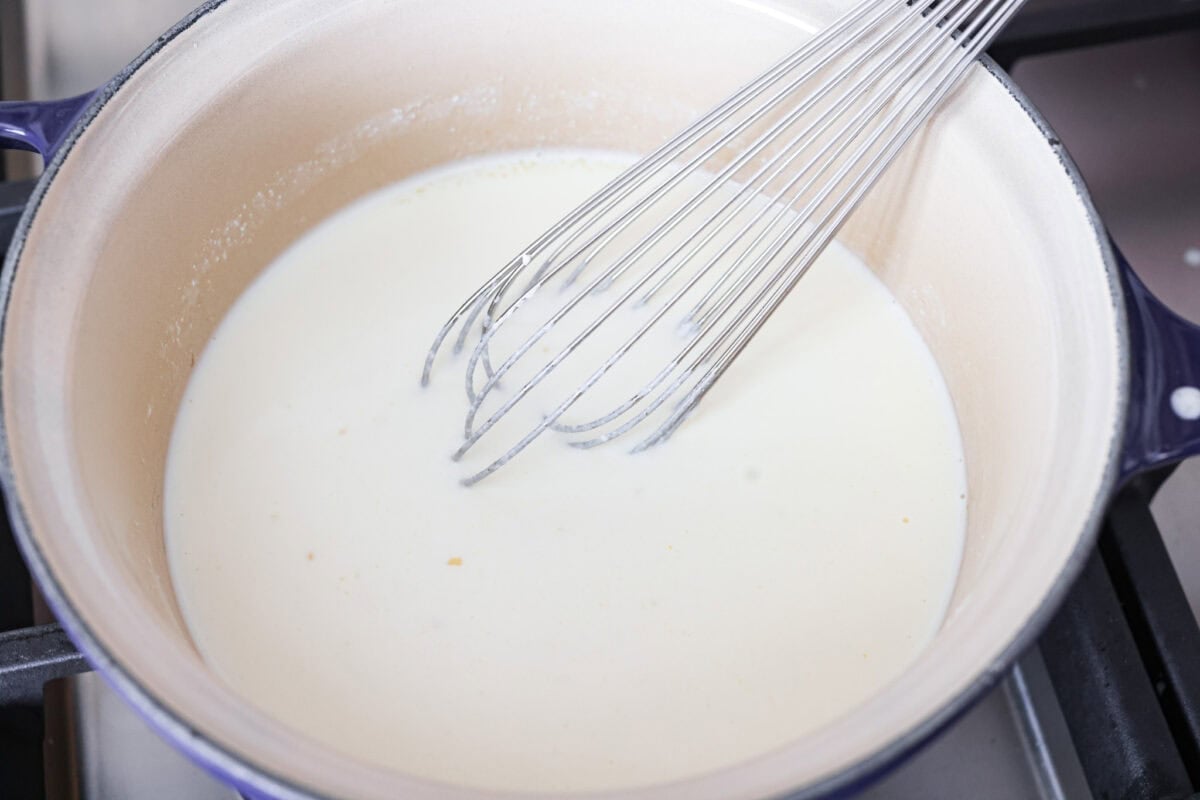 Heavy cream, pasta liquid, and ricotta cheese added to the pan with the olive oil and garlic. 