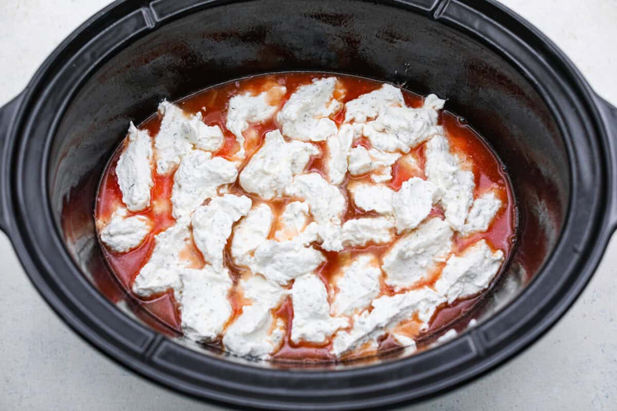 Million dollar cheese sauce dolloped onto the top of the pasta sauce.