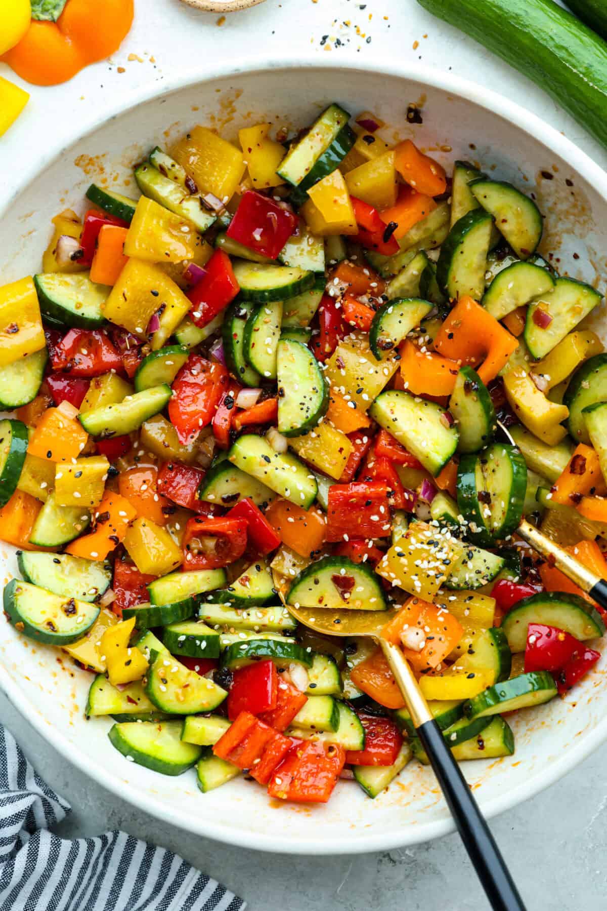 Crunchy cucumber and bell pepper salad in a large mixing bowl. 