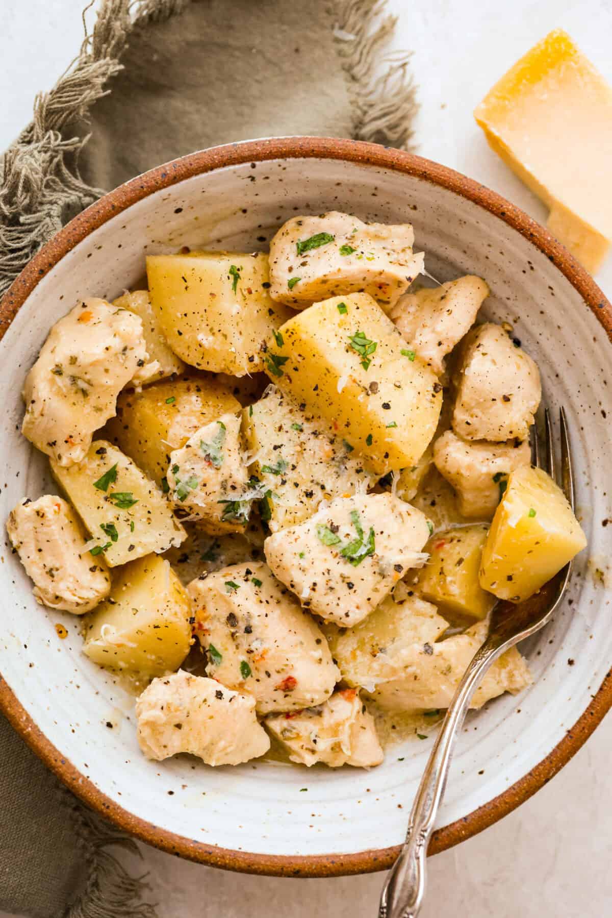 Bowl of individual serving of slow cooker parmesan garlic chicken.