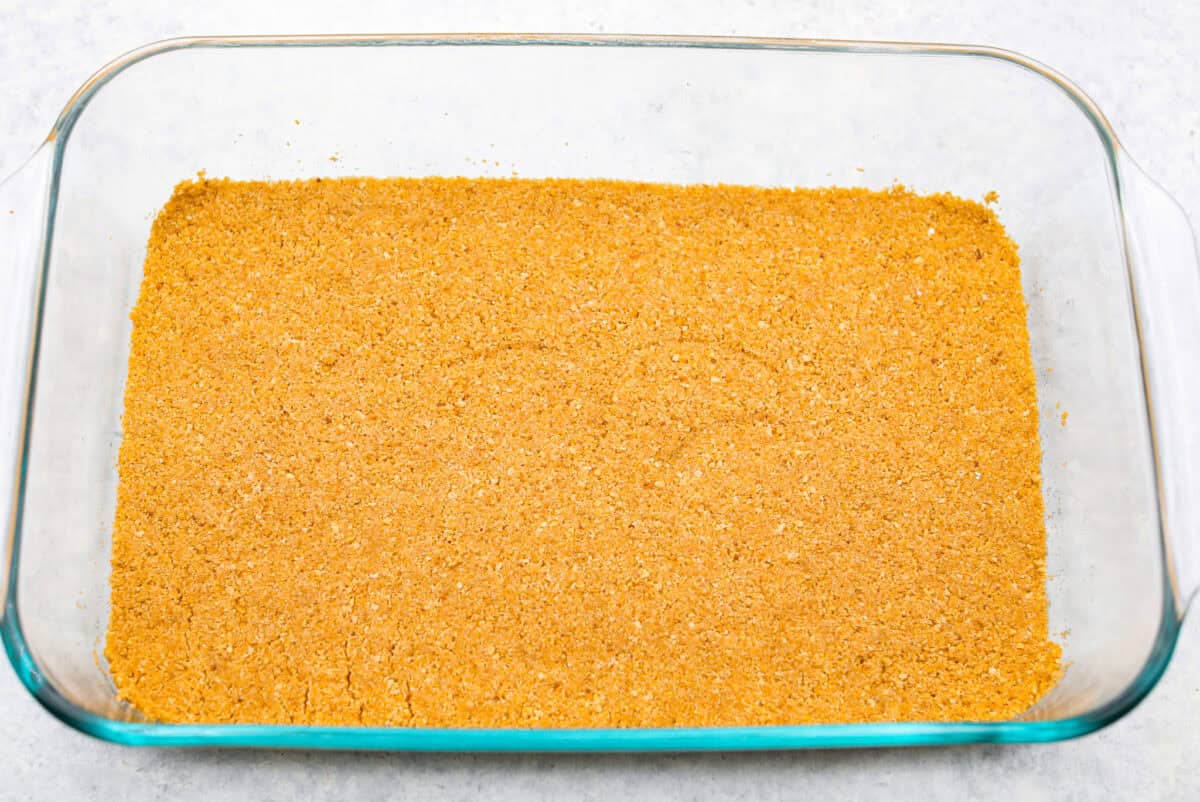 Graham cracker mixture smashed into the bottom of a 9x13 glass dish. 