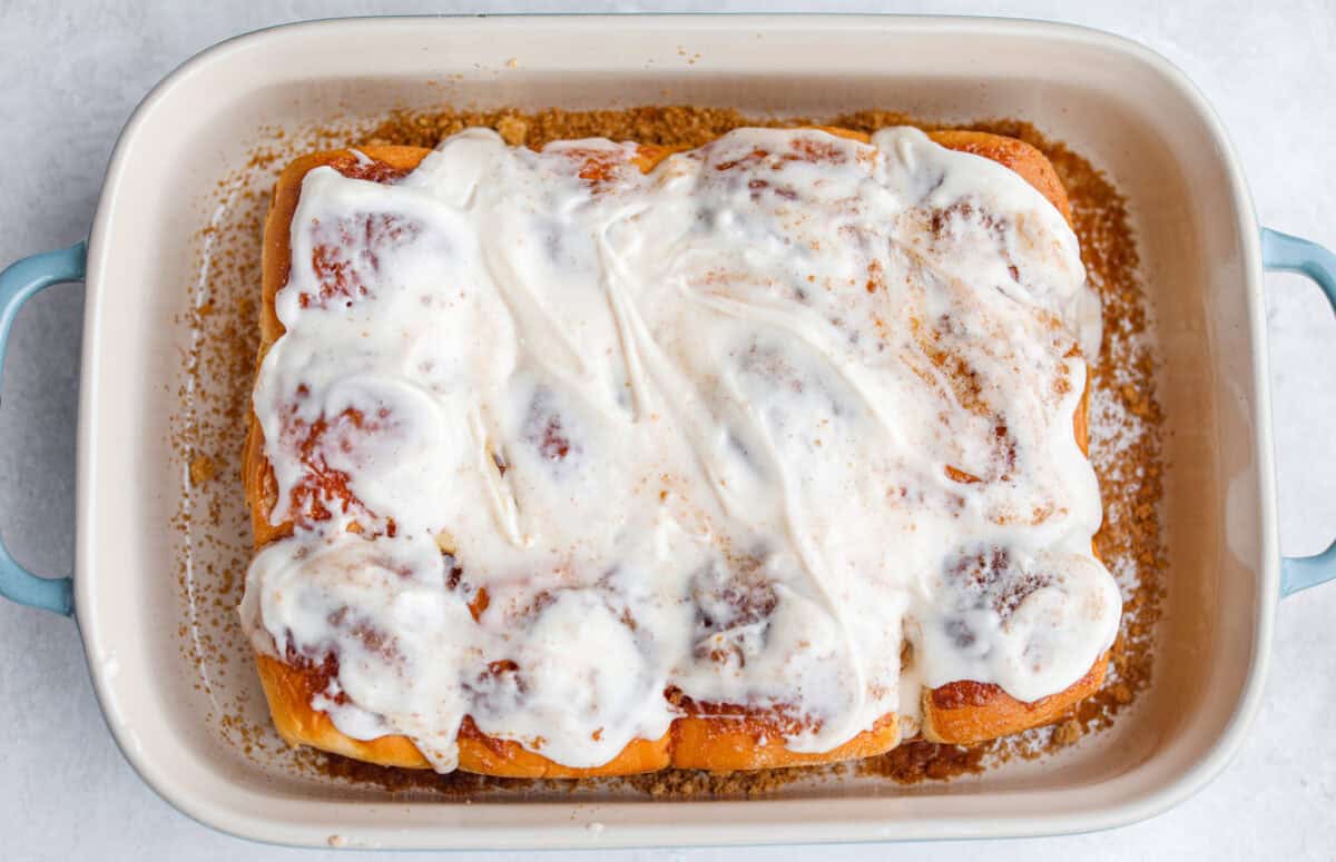 Baked Hawaiian roll cinnamon rolls topped with cream cheese frosting.
