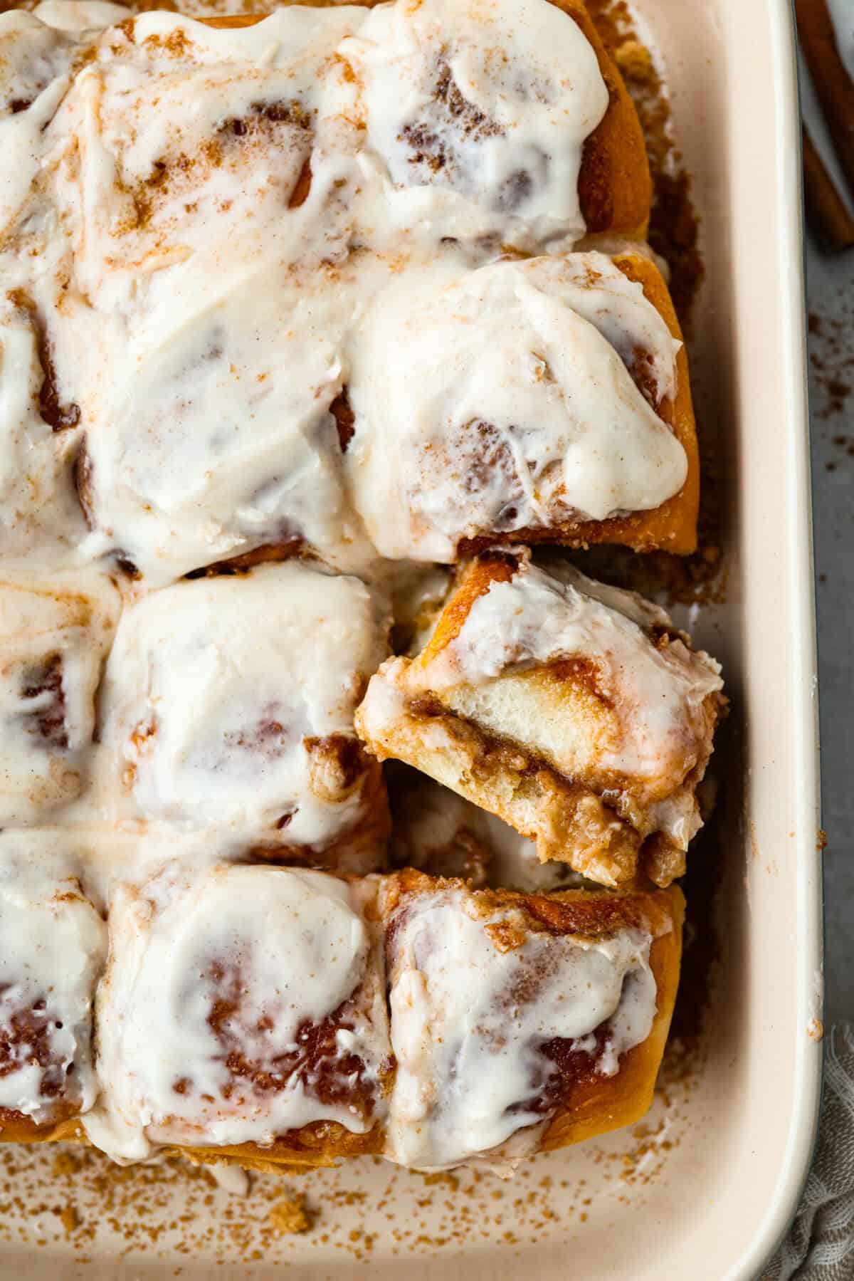Overhead shot of baked and frosted Hawaiian roll cinnamon rolls. 
