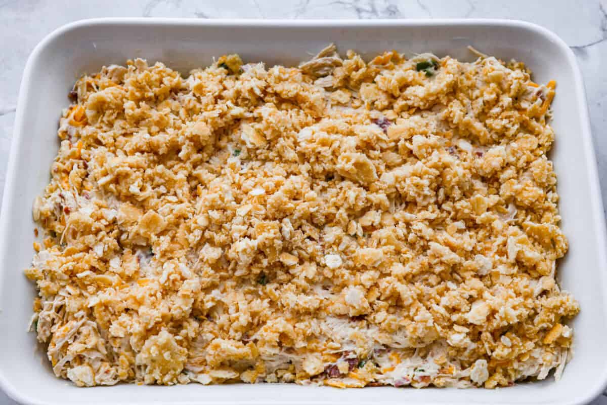 Casserole ingredients topped with ritz cracker crumb topping. 